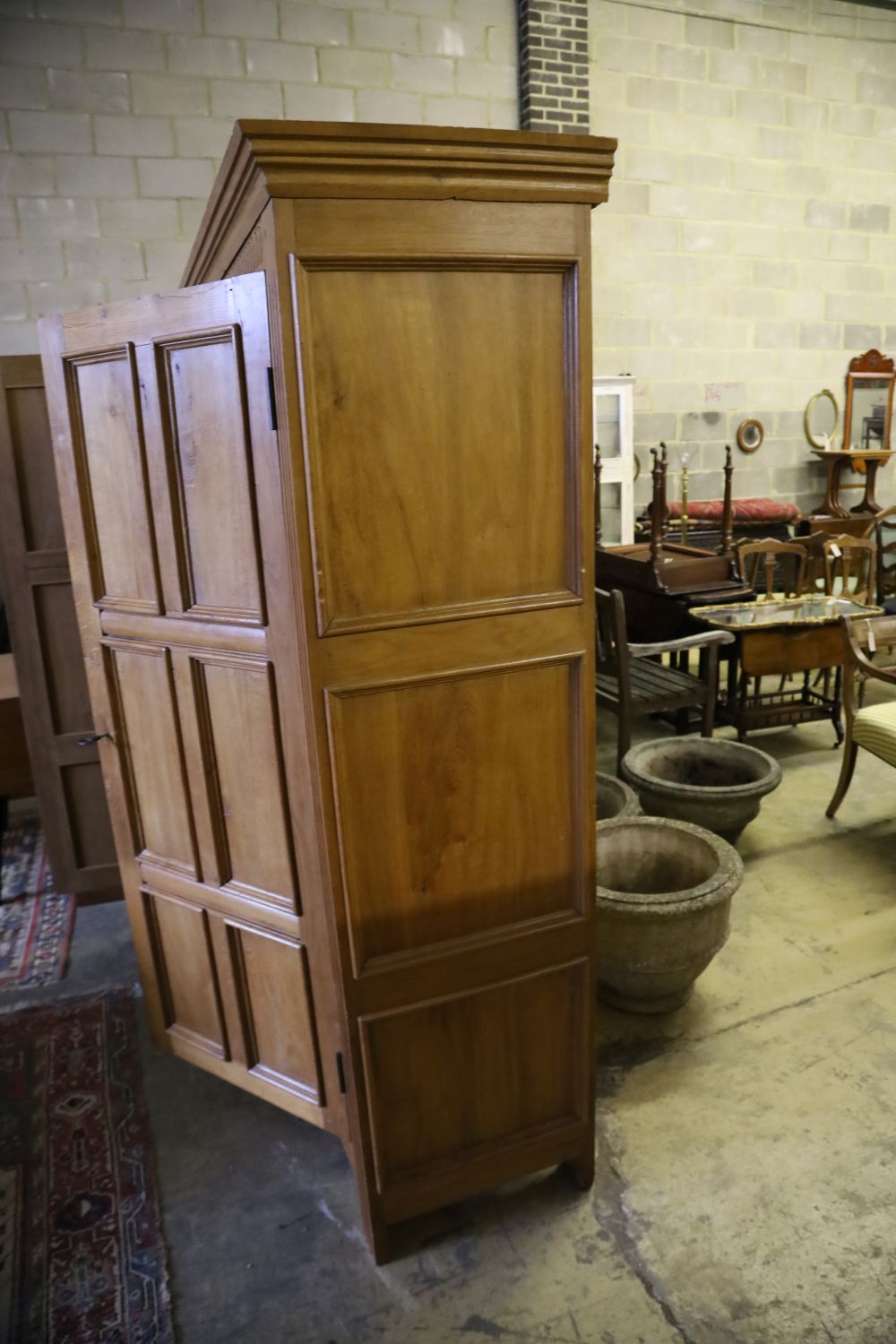 A carved and panelled oak and beech double wardrobe, width 120cm, depth 50cm, height 199cm